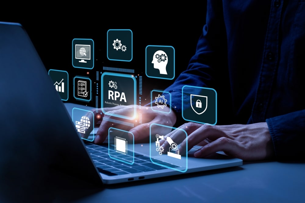 A person typing on a laptop, surrounded by floating icons representing Robotic Process Automation (RPA), artificial intelligence, and cybersecurity, symbolizing automation and digital transformation in technology.