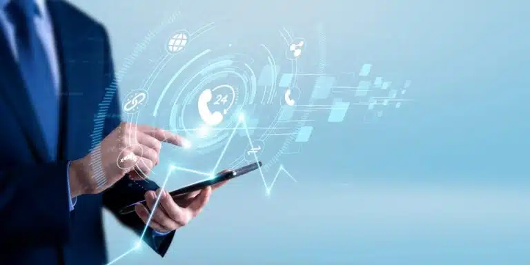 A business professional using a smartphone with a futuristic digital healthcare interface displaying communication, support, and medical technology icons on screen.