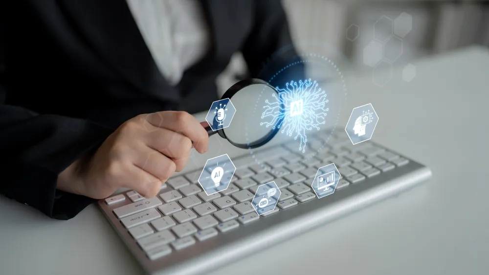 Business professional using a magnifying glass to inspect artificial intelligence (AI) cybersecurity, machine learning, and digital data protection on a computer keyboard.